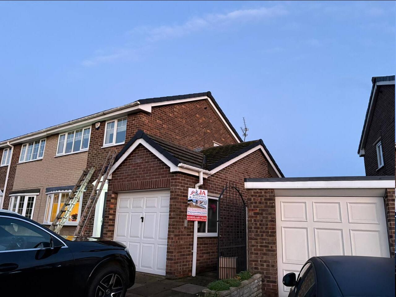 JA Roofing & Fascias roofer working at dusk in Doncaster